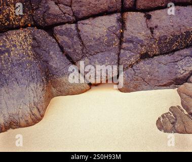 Sandstone rocks against a clean sandy beach in the Isle of Lewis, The Western Isles. Stock Photo