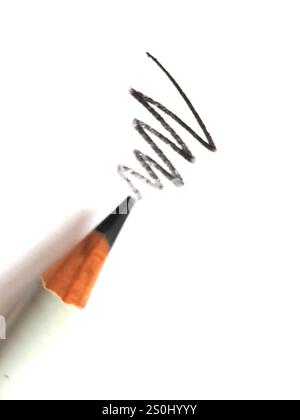 Close up of a black pencil and scribble on a white background. Stock Photo