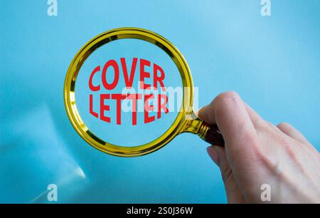 Cover Letter symbol. Concept word Cover Letter with Magnifying glass. Businessman hand. Beautiful blue background. Business and Cover Letter concept. Stock Photo