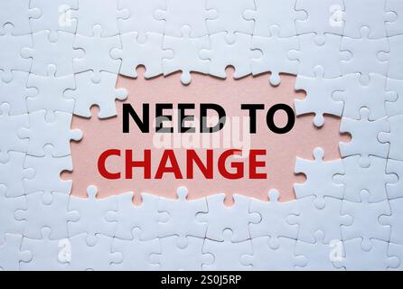 Need to change symbol. Concept words Need to change on white puzzle. Beautiful pink background. Business and Need to change concept. Copy space. Stock Photo