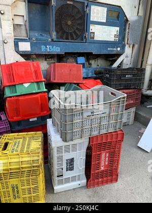 Several vented empty colorful plastic food crates Stock Photo