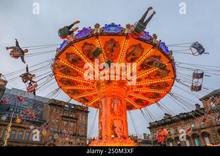 Fairground roundabout ariel swing in Christmas Winterfest carnival, George Square, Glasgow, Scotland, UK. Stock Photo