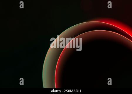 Semi circles on a black background with red and green glow Stock Photo