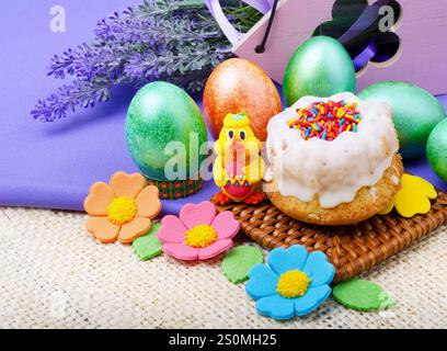Easter composition. Easter cake, painted Easter eggs and lavender branches on a background of burlap. Stock Photo