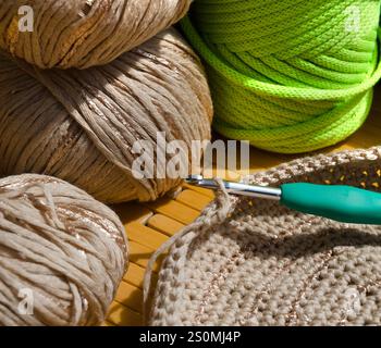Colored skeins of thread for weaving macrame and boxes with accessories. Bright thread macro on a wooden background. Stock Photo
