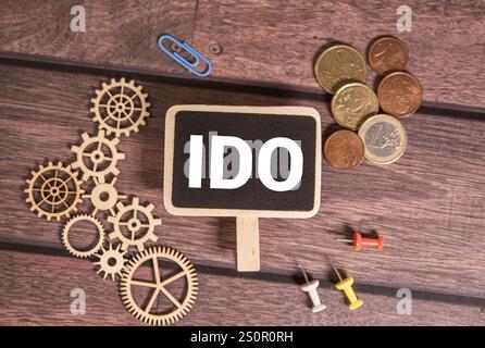 There is notebook with the word IDO (Initial DEX Offering).It is an abbreviation for IDO (Initial DEX Offering) as eye-catching image. Stock Photo