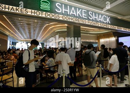 Bangkok, Thailand - April 12, 2023: People stand in line at the newly opened Shake Shack fast food restaurant in CentralWorld shopping mall. Stock Photo