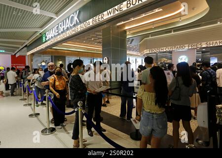 Bangkok, Thailand - April 12, 2023: People stand in line at the newly opened Shake Shack fast food restaurant in CentralWorld shopping mall. Stock Photo