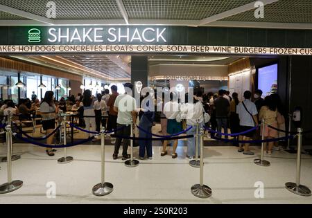 Bangkok, Thailand - April 12, 2023: People stand in line at the newly opened Shake Shack fast food restaurant in CentralWorld shopping mall. Stock Photo