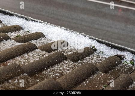 Hailstones in the gutter of a residential building Stock Photo