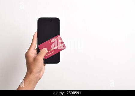 Male hands holding mobile phone and credit card isolated on white background Stock Photo