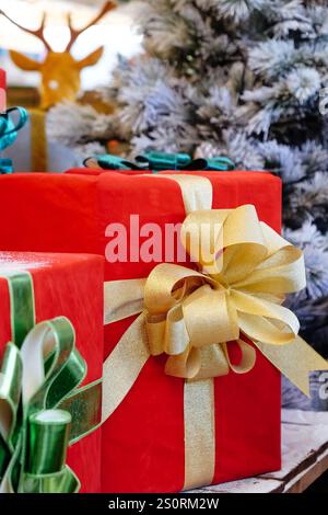 Christmas presents in red and green boxes with ribbons on wooden shelf Stock Photo