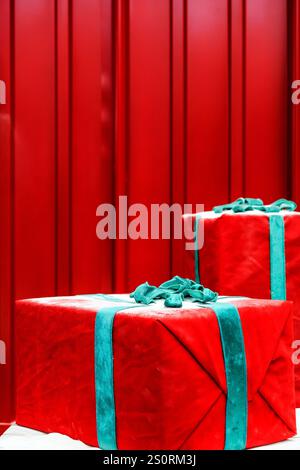 Gift boxes with ribbons on red background, close-up Stock Photo