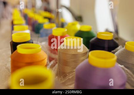Textile factory, multi-colored spools of colored threads in production, weaving machine, Stock Photo