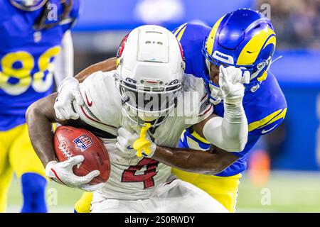 Los Angeles, United States. 28th Dec, 2024. Arizona Cardinals wide receiver Greg Dortch #4 is stopped by Los Angeles Rams wide receiver Xavier Smith #19 during an NFL football game at SoFi Stadium. Credit: SOPA Images Limited/Alamy Live News Stock Photo