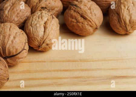 Close-up of walnuts in shell on kitchen board Stock Photo