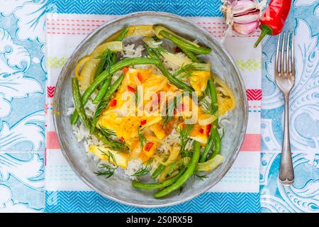 Ginger and tumerick cod with green beans and rice Stock Photo