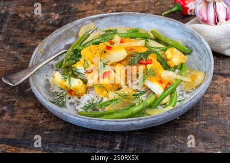 Ginger and tumerick cod with green beans and rice Stock Photo