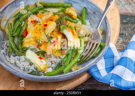Ginger and tumerick cod with green beans and rice Stock Photo