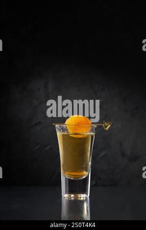 Traditional Georgian Chacha Gold, also known as grape vodka or Georgian grappa in shot glasses and dried apricots on minimalistic background. Creative Stock Photo
