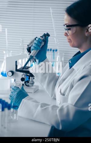 A dedicated scientist is in the laboratory, meticulously conducting detailed research using a highpowered microscope to explore various scientific Stock Photo