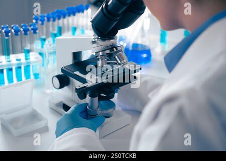 Conducting meticulous laboratory research with advanced microscopes and various test tubes allows scientists to perform detailed analyses in fields Stock Photo