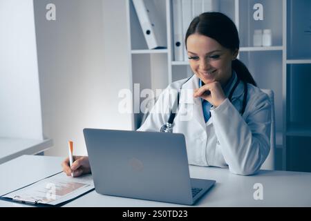 A dedicated medical professional is conducting a digital consultation with a patient, using advanced technology for thorough analysis and effective Stock Photo