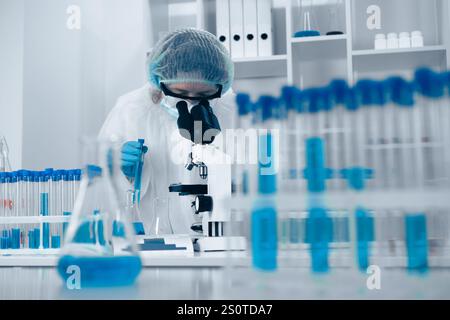 In a cuttingedge lab, a dedicated scientist is carefully examining samples using a sophisticated microscope, highlighting the importance of their Stock Photo