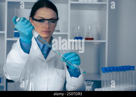 A dedicated scientist is conducting a thorough and detailed experiment in a wellequipped laboratory, focusing on key aspects of biology, chemistry Stock Photo