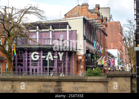 Vibrant view of a colorful canal street in Manchester, England the iconic LGBTQ G-A-Y bar with rainbow flags manchester's historic  gay village Stock Photo