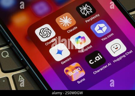 Assorted AI apps are seen on an iPhone, including ChatGPT, Claude, Perplexity, Gemini, Microsoft Copilot, You.com, Suno, Character.AI, & Hugging Chat. Stock Photo