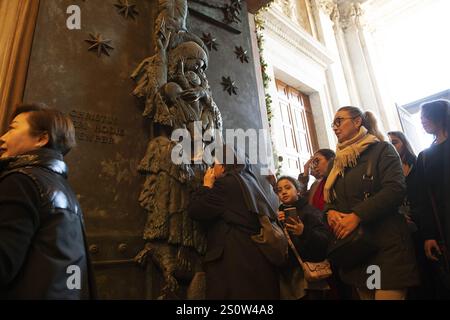 Rome, Italy. 29th Dec, 2024. **NO LIBRI** Italy, Rome, 2024/12/29 Pilgrims pass the Holy Door of St. Giovanni's Basilica in Rome. Photograph by ALESSIA GIULIANI /Catholic Press Photo Credit: Independent Photo Agency/Alamy Live News Stock Photo