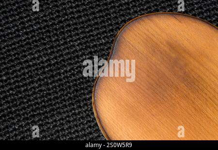 Cutting kitchen board on black raffia background. Great background for food. Stock Photo