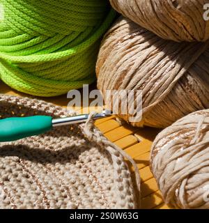 Colored skeins of thread for weaving macrame and boxes with accessories. Bright thread macro on a wooden background. Stock Photo