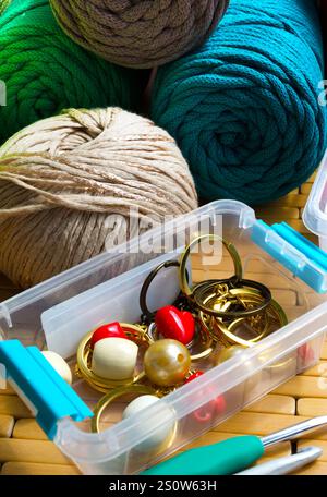 Colored skeins of thread for weaving macrame, knitting and crocheting. Box with accessories and cotton eco-threads. Stock Photo