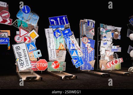 Cyrillic Road Sign Art Installation Illuminated in Desert Night Stock Photo