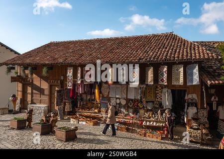 Traditional Ottoman market in Kruja. Flea market. Old Bazaar in Kruje Albania with stalls selling handmade colorful carpets, souvenirs, T-shirts and t Stock Photo