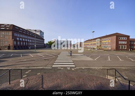 Town hall square, tax office, former post office, citizens' office RATRiUM, car park with parking boxes and zebra crossing, stairs made of red bricks Stock Photo