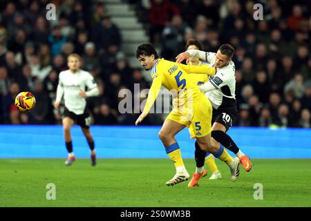 Leeds United's Pascal Struijk and Derby County's Jerry Yates (right) battle for the ball during the Sky Bet Championship match at Pride Park, Derby. Picture date: Sunday December 29, 2024. Stock Photo