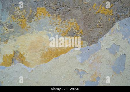 Faded and peeling paintwork on rendered wall of old building in Mdina, Malta Stock Photo