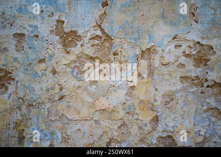Faded and peeling paintwork on rendered wall of old building in Mdina, Malta Stock Photo