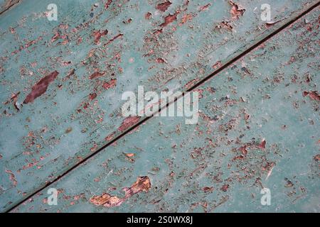 Faded and peeling green paint on an old wooden door in Mdina, Malta Stock Photo