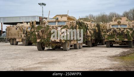 close-up of camouflaged British army 6x6 6-wheel drive Mastiff Protected Patrol Vehicles on a military exercise Stock Photo