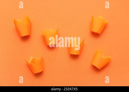 Set of paper muffin baking cups on orange background Stock Photo