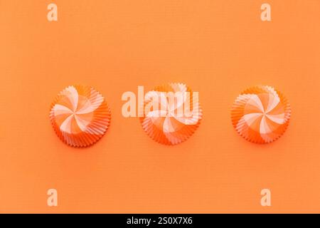 Set of paper muffin baking cups on orange background Stock Photo