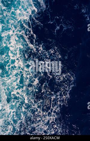 Aerial view of the dark blue ocean with textured water patterns and ...