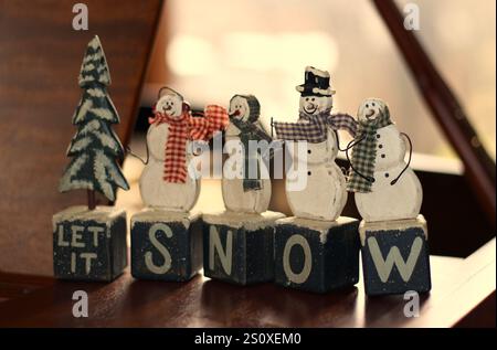 Let it Snow Christmas decoration sitting on a piano Stock Photo