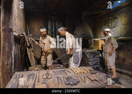 Workers at a blacksmith, metal shop. At the Agricultural Museum in Seoul, South Korea. Stock Photo