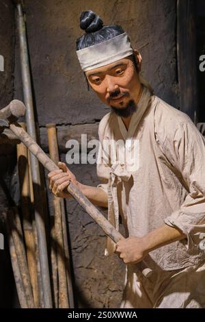 Worker at a blacksmith, metal shop. At the Agricultural Museum in Seoul, South Korea. Stock Photo