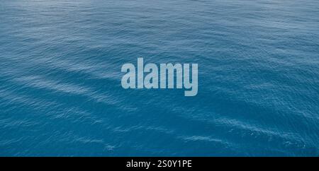 Calm ocean water surface texture background with gentle waves ripples perfect for nature seascape background. wallpapers design projects featuring tra Stock Photo